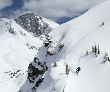 Snowboarder shredding in deep back country powder