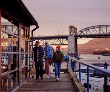 Bridge, sunset and shoppers at granville island