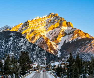 The sun shining on the mountain overlooking Banff