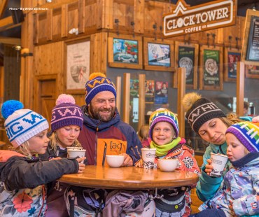 Family enjoying a hot drink and break from the slopes at Clock Tower Coffee