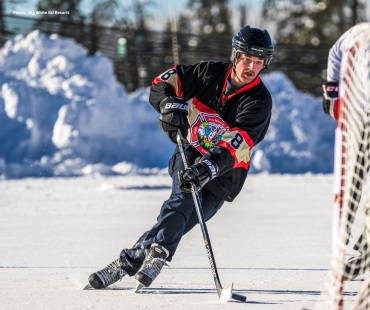 Playing ice hockey in big white jersey