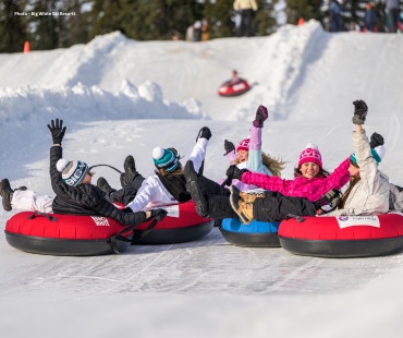 Kids enjoying sliding down the tube park slopes