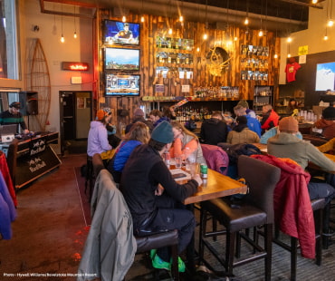 People enjoying craft beers in Mac Tavern at revelstoke