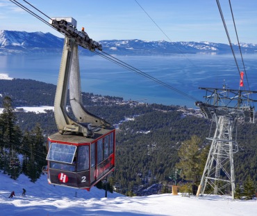 Heavenly large gondola going up the hill 