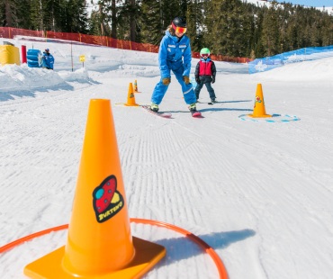 Instructor teaching young skier