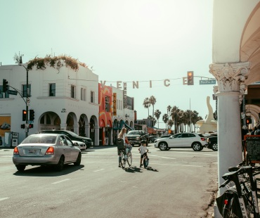 The sign hanging between buildings on Venice Beach