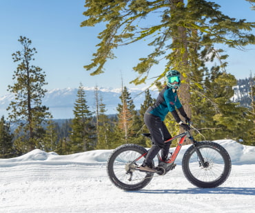 Person riding winter fat bike on trails at northstar