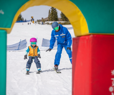 Instructor and young skier learning to ski