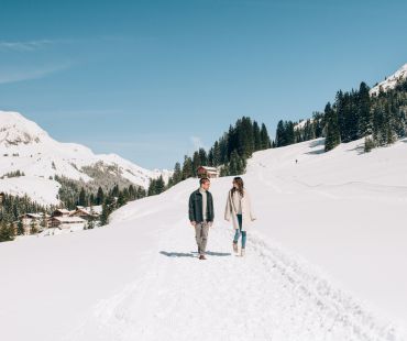 People walking through snowy trails