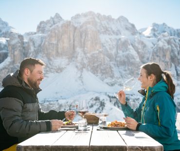 Couple enjoying gourmet meal with mountain views