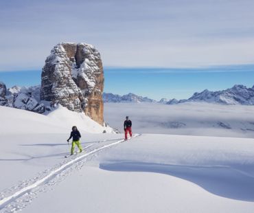 Skiers trekking through peaks of the dolomites