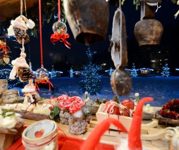 Christmas market stalls with lit up trees