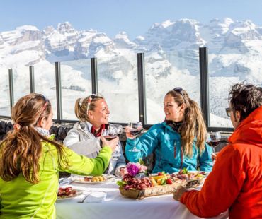 4 people enjoying gourmet food and local wines