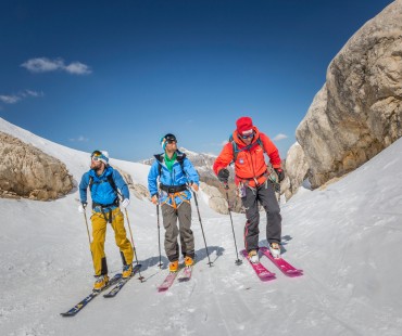 People trekking uphill in the backcountry