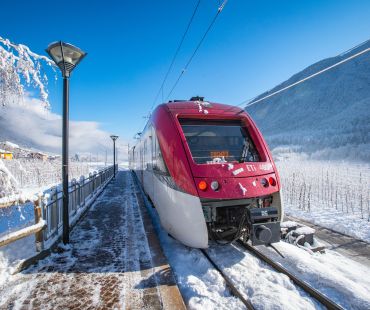 the red train running through the Val di Sole