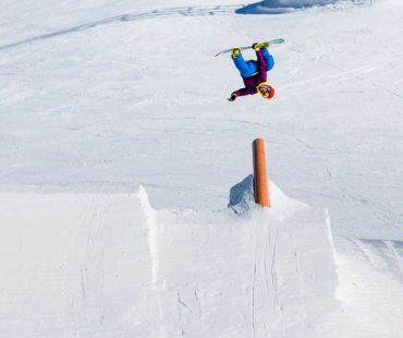 Snowboarder doing trick in the snowpark