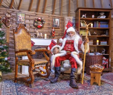 Santa sitting in christmas village