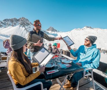 couple being served at mountain restaurant with mountain views