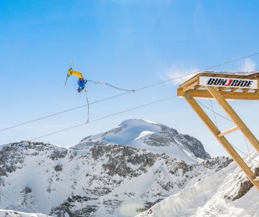 Skier launching off zipline ski jump