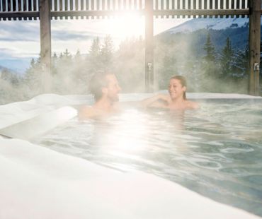 people relaxing in steamy pool