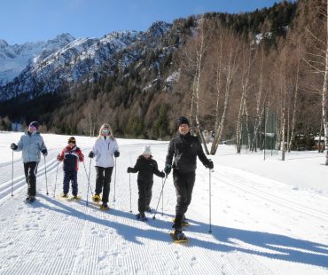 Family walking in snowshoes on snowy trails