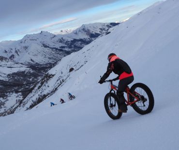 Person riding fat bike on snowy trails