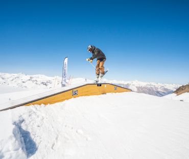 Rider sliding on rails at the snow park