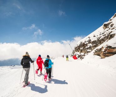 People hiking the snowy trails in snowshoes