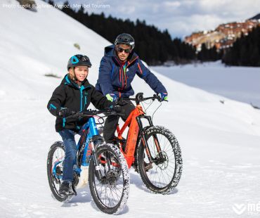 Father and son riding Fat Bikes through the snow