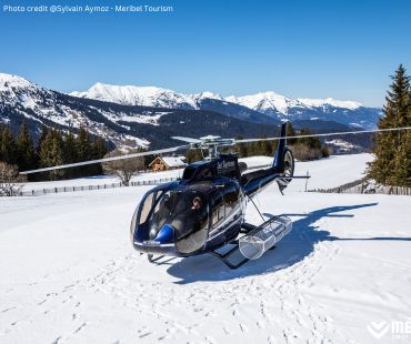 Black helicopter parked on the snow