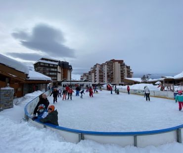 People enjoying the ice skating on the ice rink