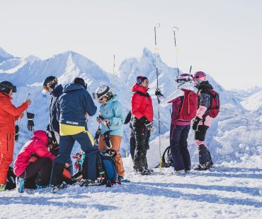 Skiers at the top of the mountain preparing to race in the open