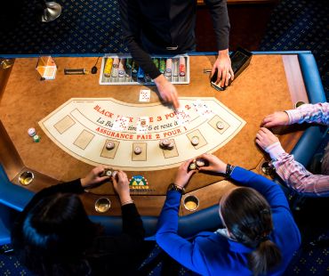 People playing table games at the casino