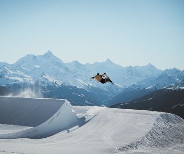 Skier launching off Jump at Crans Montana