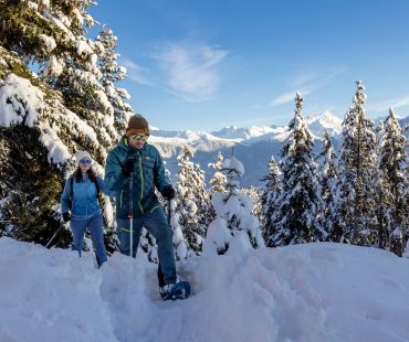 People snowshoeing through fluffy powder snow