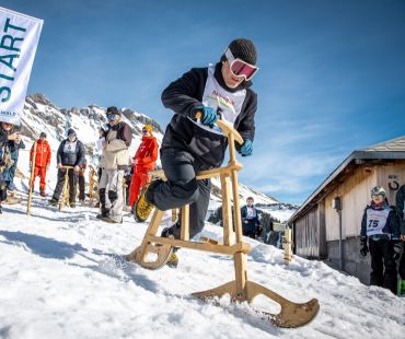 person riden wooden ski bike