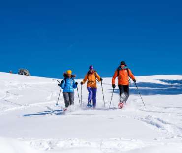 Group of friends snowshoeing at Val Gardena