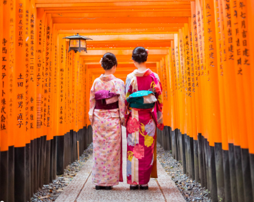 Geisha walking through Fushimi Inari Shrine