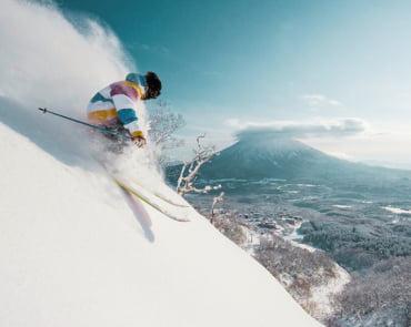 Skier at Niseko with Mount Yotei in the background